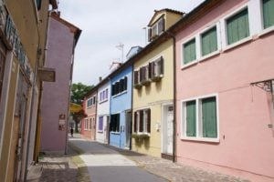 Brightly colored houses on a side street in Burano, Italy