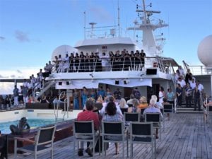 Most of the staff say "thanks" to the passengers on the last night of the cruise.