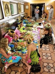 Festive sights - Polynesian night aboard the Paul Gauguin. Locals teaching passengers how to make flower headdress and lei